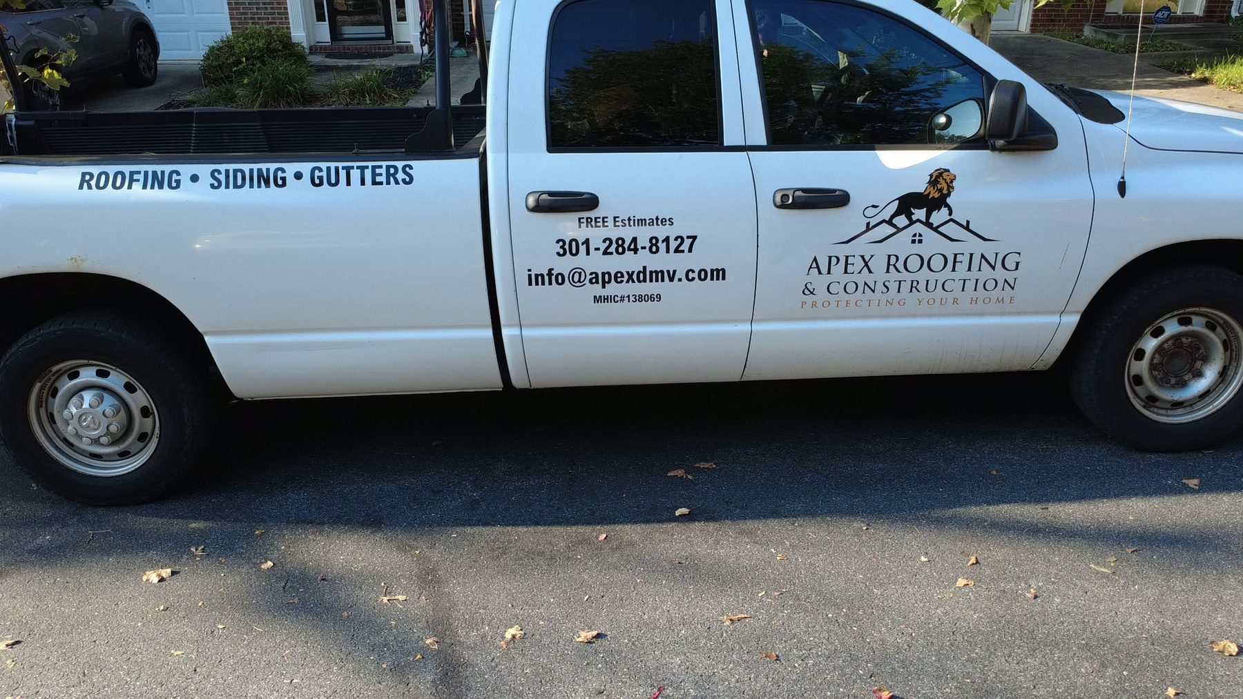 Apex Roofing and Construction yard sign staked on a residential lawn