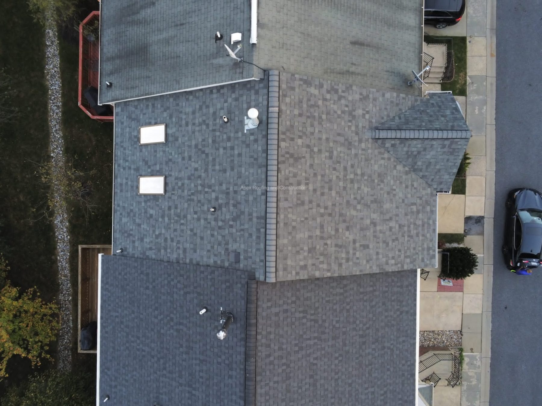 Drone photo of new architectural shingles across a multi-slope residential roof