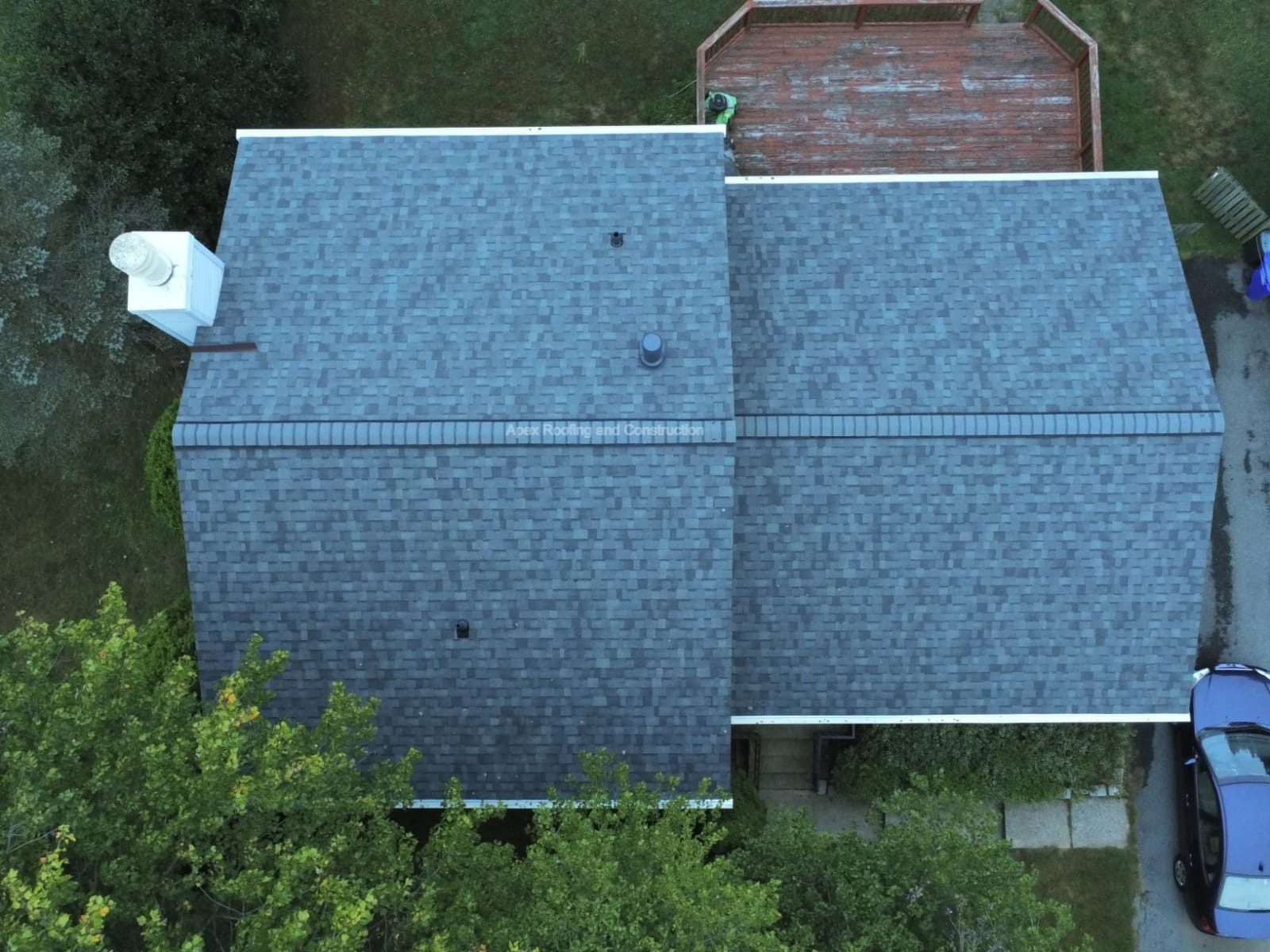 Overhead drone view of a finished residential roof with new ridge venting