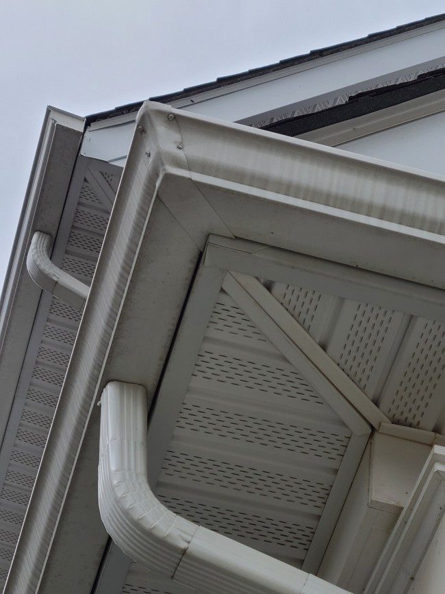 Seamless aluminum gutter corner detail installed on a home
